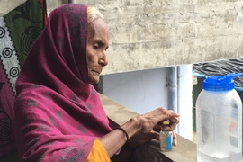 Field test participant Asma Patham uses a water test kit in the Khodiyarnagar neighborhood of Ahmedabad.