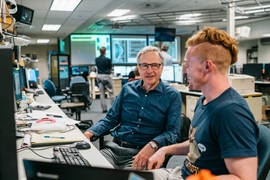 Alex Tingly (right), a graduate student in the Department of Physics, and senior research scientist Earl Marmar, head of the Alcator C-Mod project since 2002, review data on synchrotron emission from relativistic electrons in plasma.