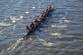 To the cheers of teammates and family on the Weeks Footbridge, the Varsity 8 row by in synch, steadily gaining on Princeton University at the Head of the Charles Regatta. Along with a four-rower boat in lightweight women’s crew, the MIT rowers are about to make program history. Left to right: Chloe Thacker (coxswain), Priya Veeraraghavan (captain), Sharon Wu (captain), Elizabeth Martin, Annika R...