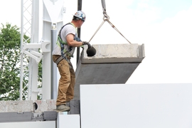 A precast concrete section is lifted into place for a net-zero home built in Edmonton, Alberta, Canada. 
