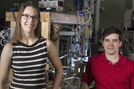 PhD candidate Emily Tow (left) and postdoc David Warsinger co-led a study proposing new designs for reverse osmosis desalination that significantly exceed the energy efficiency of state-of-the-art techniques. An experimental prototype is behind them.