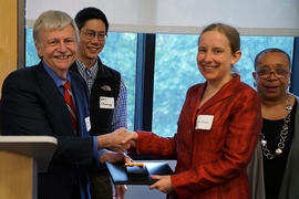 Tracy Robyn Slatyer, the Jerrold R. Zacharias CD Assistant Professor in the Department of Physics, receives her award from Dennis Freeman, dean for undergraduate education.