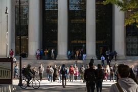 People walking into and out of MIT's main entrance