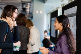 Anne Collin (left), a PhD student in the Department of Aeronautics and Astronautics, talks with Sruthi Davuluri, a Technology and Policy Program Master’s student, during the Women in Data Science conference student poster session.