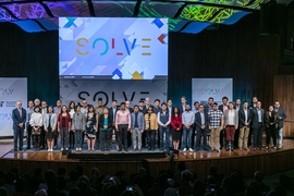 Solver teams with MIT President L. Rafael Reif (far left) on stage during Solve at MIT.