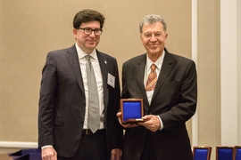 Professor Oral Buyukozturk (right) accepts the George W. Housner Medal for Structural Control and Monitoring from ASCE EMI President George Deodatis.