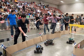 Students in the Beaver Works Summer Institute’s Autonomous RACECAR course follow their cars around a racetrack during the program’s final race.