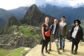 Left to right: Paloma Gonzalez, Associate Professor Takehiko Nagakura, Chang Liu, and Wenzhe Peng pose with a panoramic view of Machu Picchu in Peru. They are part of an MIT team that has worked to digitally document the site.