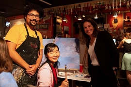 Chancellor Cynthia Barnhart (right) poses with Paint Nite organizers Shaiyan Keshvari (left) and Xueying Zhao.
