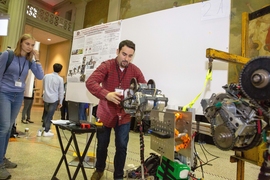 Graduate student Daniel Gonzalez demonstrates his Extra Robotic Legs system at the Mechanical Engineering Research Exhibition (MERE). The system was designed to increase the effectiveness of hazardous material emergency response personnel who are encumbered by their personal protective equipment.