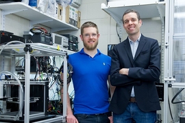 Associate Professor A. John Hart (right), doctoral student Adam Stevens SM ’15, and their colleagues have designed a 3-D printer that can deposit material 10 times faster than today’s desktop models can. The team has also developed a novel process for 3-D printing using cellulose, a widely available natural polymer.