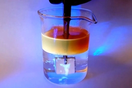 Researchers demonstrating the ability of aluminum to repel oil underwater.