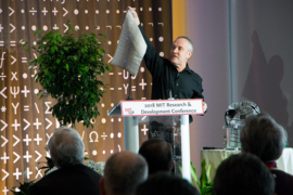 Yoel Fink, CEO of AFFOA, holds up a fabric with optical communications capabilities during a presentation on what he calls “fabrics as a service” at the annual MIT Industrial Liaison Program (ILP) Research and Development Conference on Nov. 15.