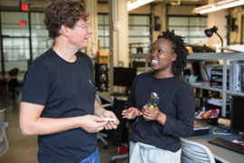 Professor Reinhart (left) and architecture graduate student Hellen Rose Anyango Awino discuss a class assignment on measuring thermal comfort.