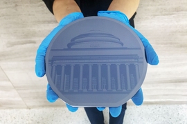 “One.MIT,” a new art installation at MIT.nano, displays a 6-inch silicon wafer depicting an image of MIT’s Great Dome. The image was formed by etching the names of the more than 270,000 people associated with the Institute from 1861 to spring 2018.