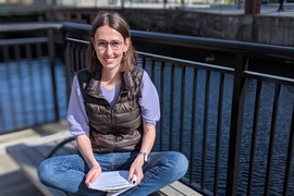 2018-19 J-WAFS Fellow Andrea Beck sits by the Charles River.
