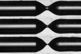 Series of images from the team’s lab experiments shows the process of “pinch-off” where the air bubble (black) starts to separate as it penetrates into a liquid environment (white) inside a narrow tube.
