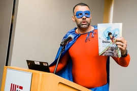 Shawn Robinson, senior research associate at the University of Wisconsin at Madison, helped kick off the first-ever MIT Science of Reading event dressed in full superhero attire as Doctor Dyslexia Dude — the star of a graphic novel series he co-created to engage and encourage young readers, rooted in his own experiences as a student with dyslexia. 