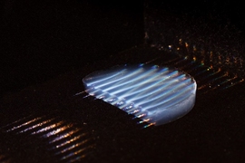 The new aerogel insulating material is highly transparent, transmitting 95 percent of light. In this photo, parallel laser beams are used to make the material visible.