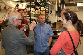 Professor J. Kim Vandiver, Mark Belanger, and others celebrate the Edgerton Student Shop's move across Vassar Street. The new shop is next door to the Metropolis Shop, part of Project Manus.