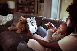 woman-with-baby-looking-at-ipad