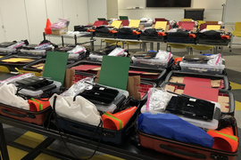 About 30 RACECAR model kits on tables in an otherwise emtpy classroom