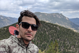 Photo of Eaman Jahani with mountains behind him