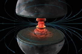 An illustration of the grey moon cut in half with internal red spheres and lines representing magnetic field lines