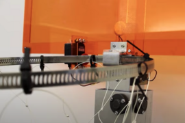 Orange basketball backboard holds a mechanical hoop