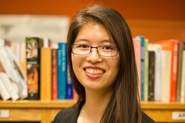 Portrait photo of Cathy Wu with a bookshelf in the background