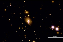 Image of space featuring a purplish glowing blob at center and two bright star at lower right