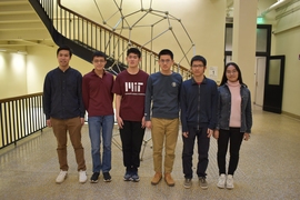 Photo of six students standing in Department of Math hallway.