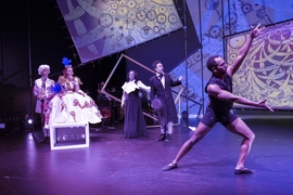 Omar Najimi, Erin Matthews, Aliana de la Guardia, Aaron Engebreth stand in 19th century costumes on a stage while Henoch Spinola dances in more modern dress 
