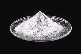 research on renewable energy technologies A mound of white powder sits atop a glass plate.