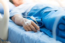 Person in repose in a hospital bed; you cannot see their face