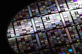 A close-up shot of a superconducting qubit wafer, showing microfabricated circuits