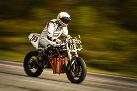 Person riding a hydrogen-powered electric motorcycle at high speed