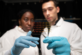 research paper on casting process Eunice Aissi, left, and Alexander Siemenn each hold up a clear mat with dotted samples with gloved hand. They are wearing lab coats.