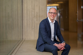 Zachary Smith sits in a hallway on campus