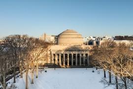 Aerial photo of MIT building 10 and Killian Court with snow on the ground
