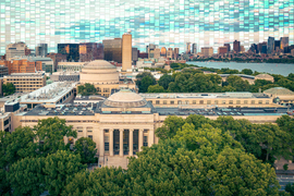 MIT campus with Kendall Square hub in background and decorative sky.