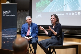 William Green and Emily Carter sit in front of a slide projected on a stage
