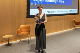 Annaliese Meyer stands with her Envisioning the Future of Computing prize winner statue.