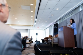 Evelyn Wang speaks at a lectern
