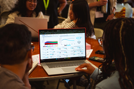 Students look at the En-ROADS simulator on a laptop screen