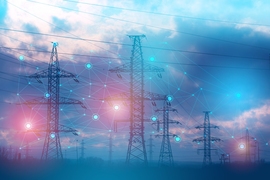 Photo of high-tension power lines at night overlaid with circular glowing orbs connected by lines representing power.