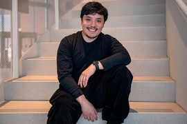 Mariano Salcedo poses seated on a staircase