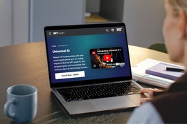 An open laptop with the Universal AI program page on screen.