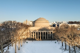 Aerial photo of the MIT Dome and Killian Court with snow on the lawn