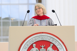 Sally Kornbluth speaks at podium on stage.